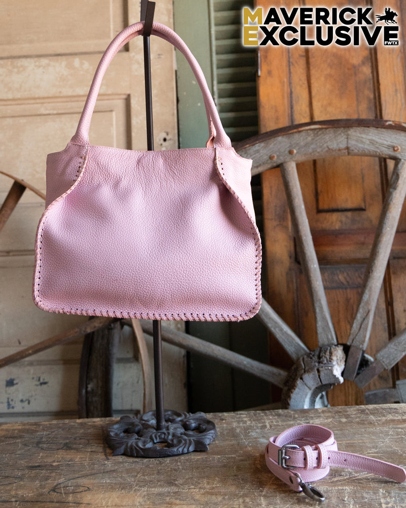 Pink handbag and matching dog collar on a wooden surface with rustic background