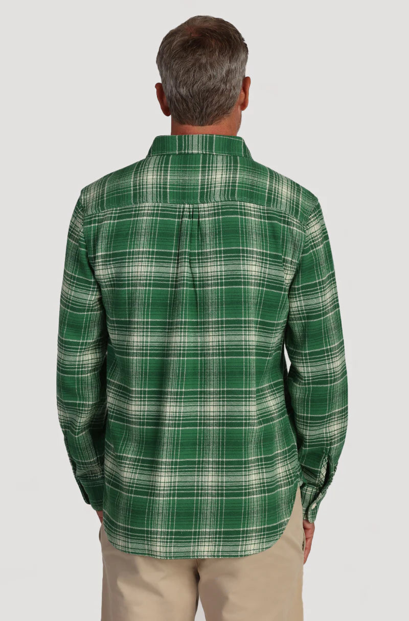 Man wearing green plaid button up shirt with double breast pockets on the front 