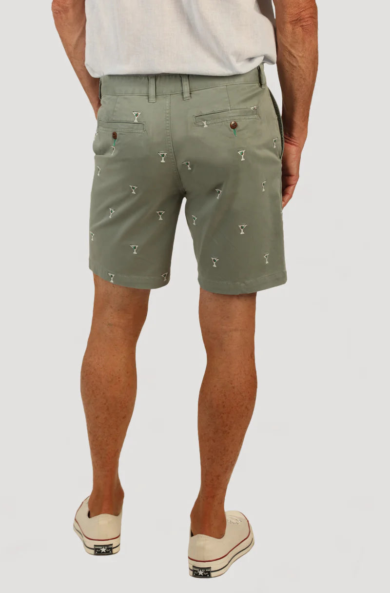 Man wearing sage green shorts with martini glasses all over