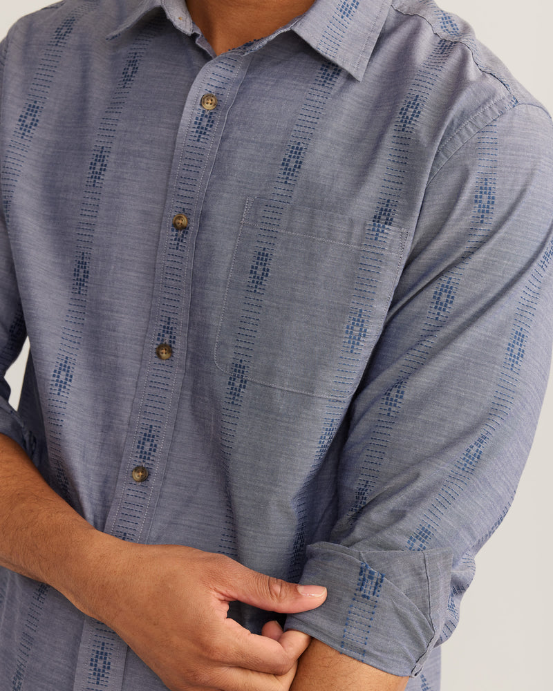 MAN WEARING LONG SLEEVE CHAMBRE BUTTON DOWN SHIRT WITH BLUE TRIBAL PATTERN