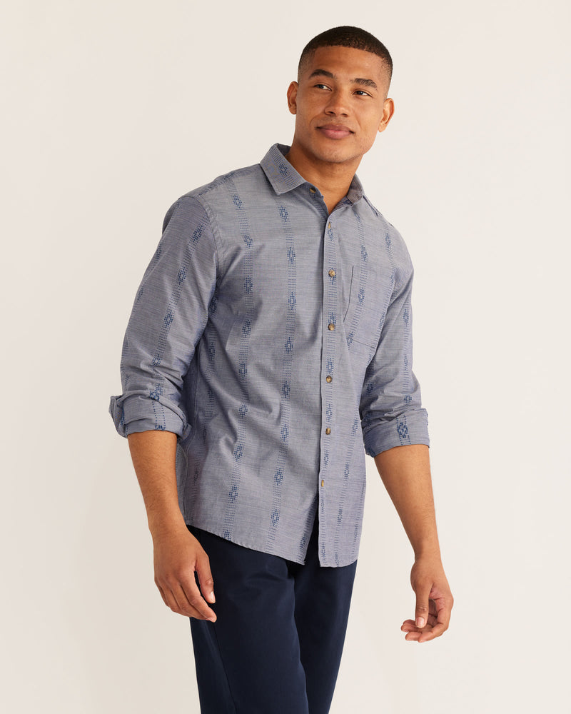 MAN WEARING LONG SLEEVE CHAMBRE BUTTON DOWN SHIRT WITH BLUE TRIBAL PATTERN