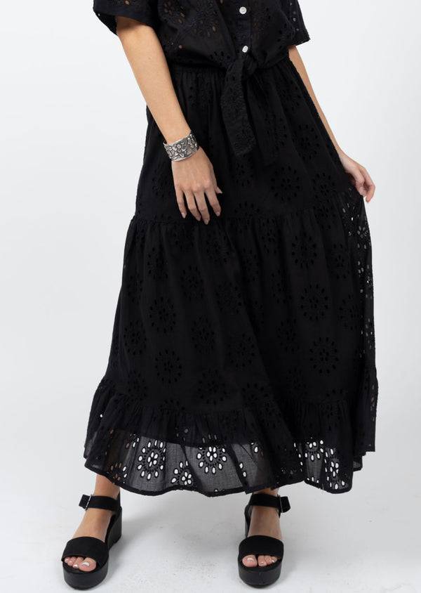 Woman wearing black maxi skirt with eyelet detailing