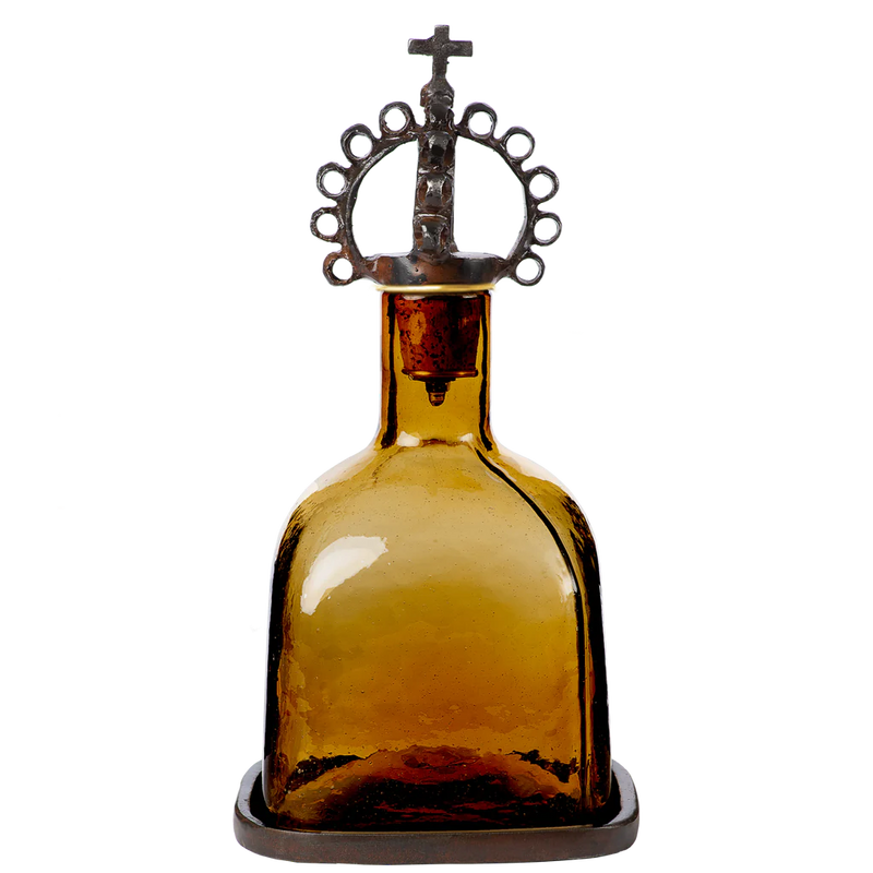 Mouth blown decanter, the color of toasted tobacco, resting in a wax cast tray, topped with a jubilant