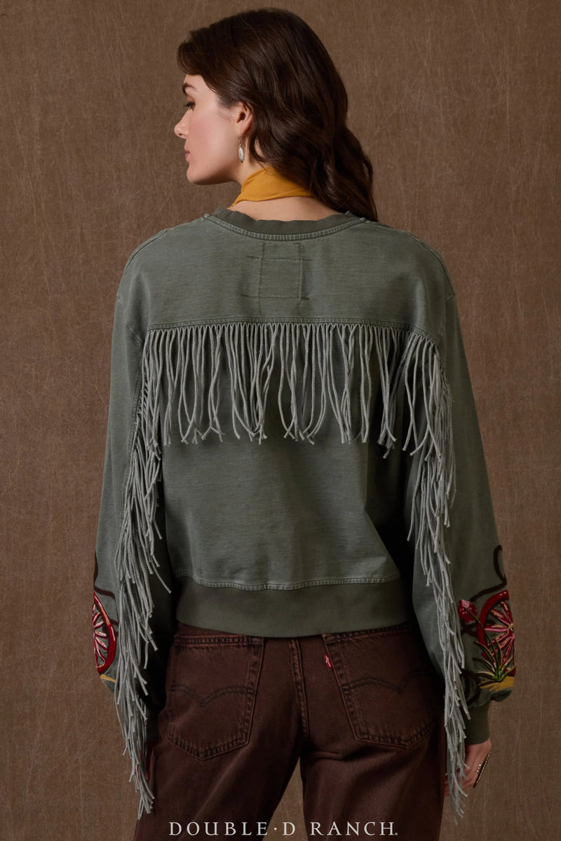 Person wearing a green fringed jacket with Double-D Ranch branding on a brown background