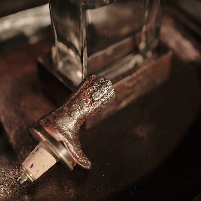 Close-up of a metallic lever mechanism on a dark background