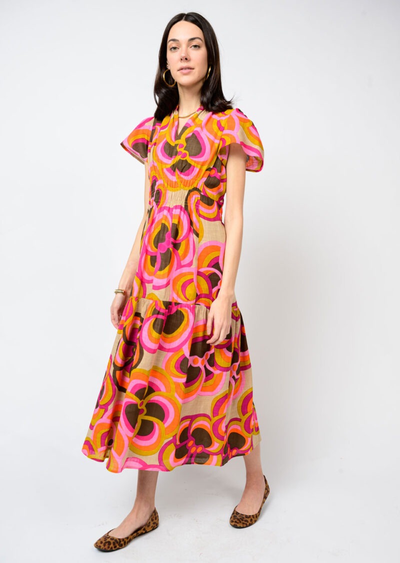 Woman wearing a colorful patterned dress on a white background