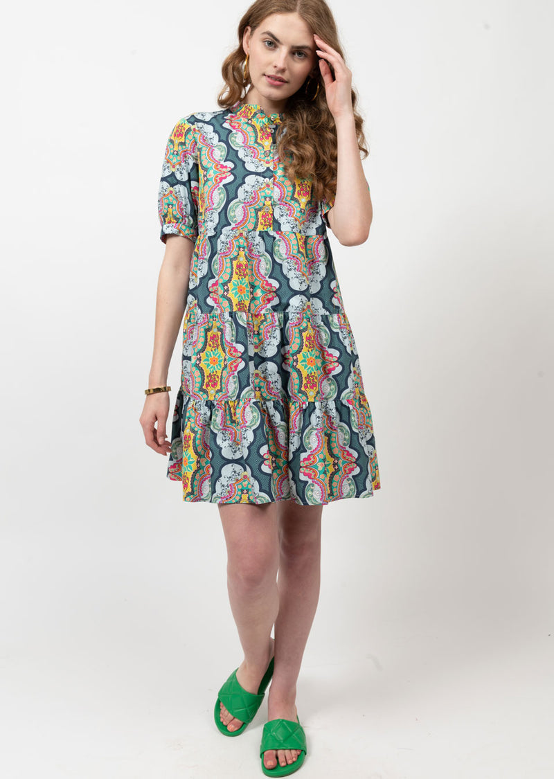 Woman wearing mini dress with multicolor pattern all over
