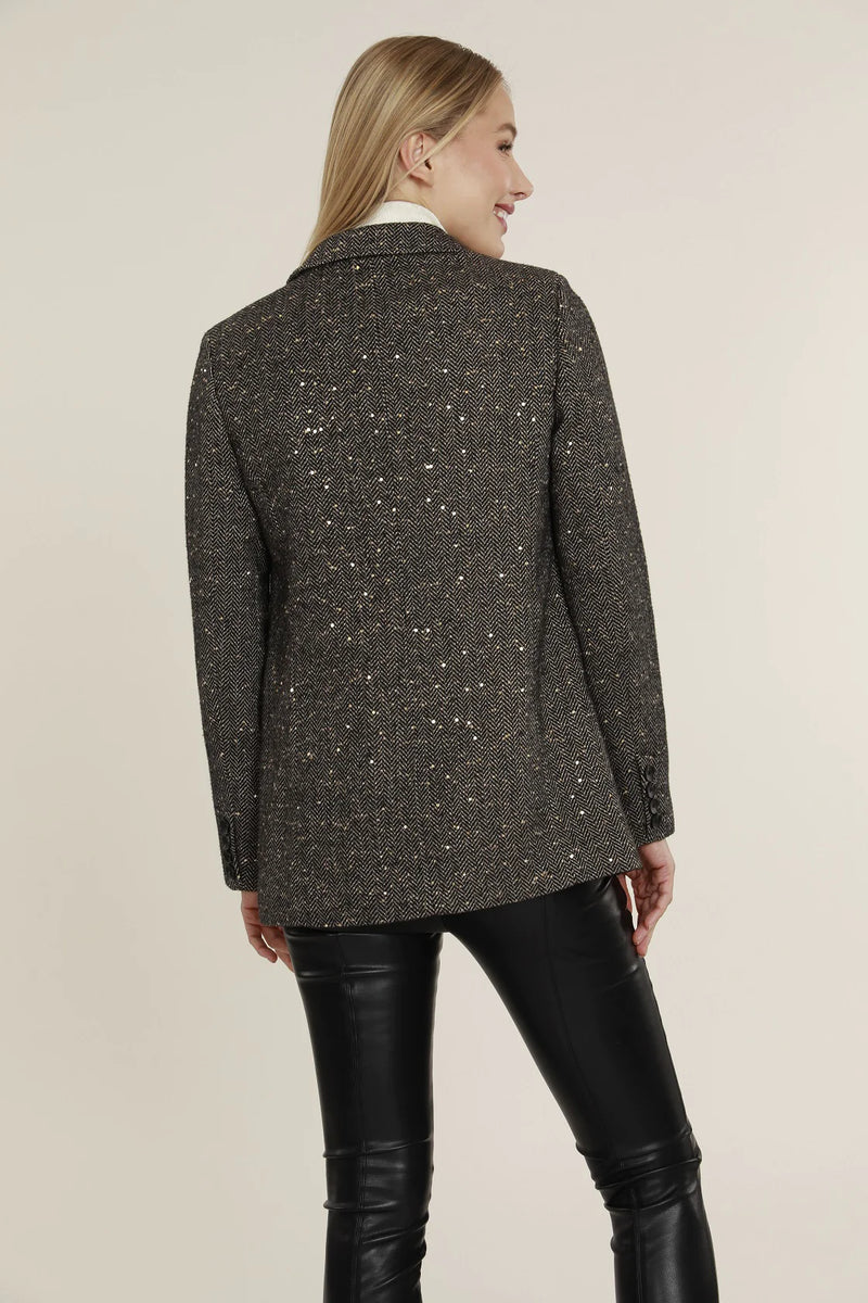 woman wearing tweed blazer with sequins on it