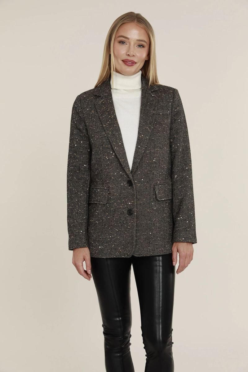 woman wearing tweed blazer with sequins on it