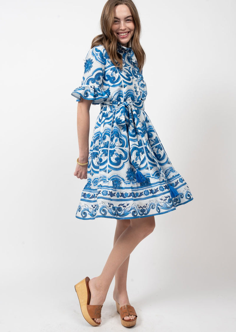 Woman wearing white and blue spanish tile print dress
