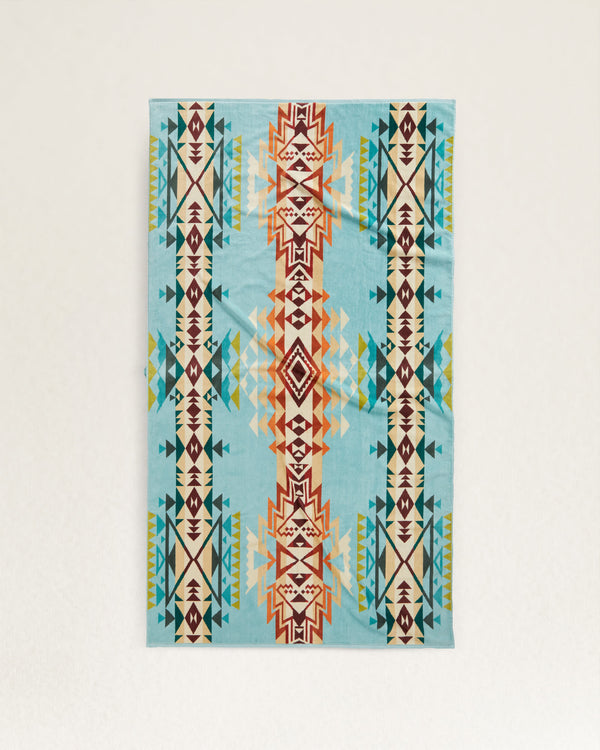 Spa towel in a tribal pattern in a blue, orange, green, white and purple color way