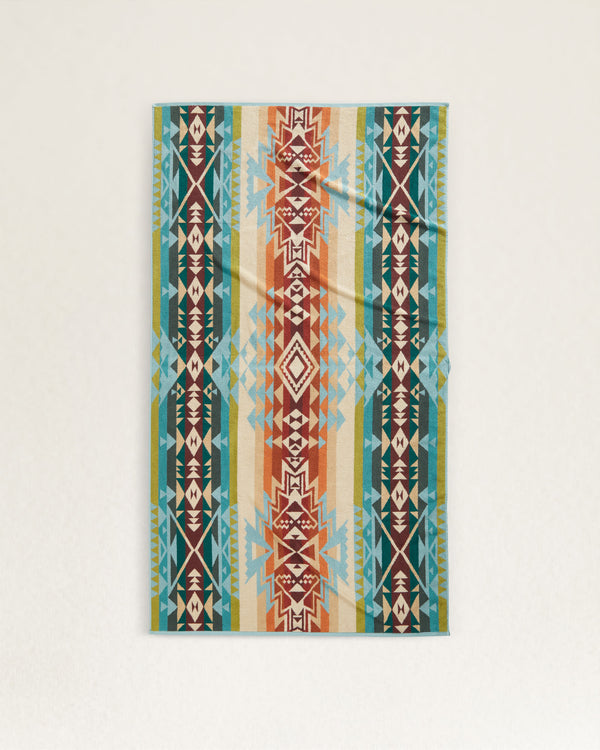 Spa towel in a tribal pattern in a blue, orange, green, white and purple color way