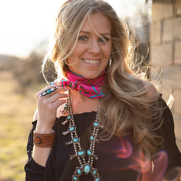Woman wearing a colorful necklace and scarf outdoors