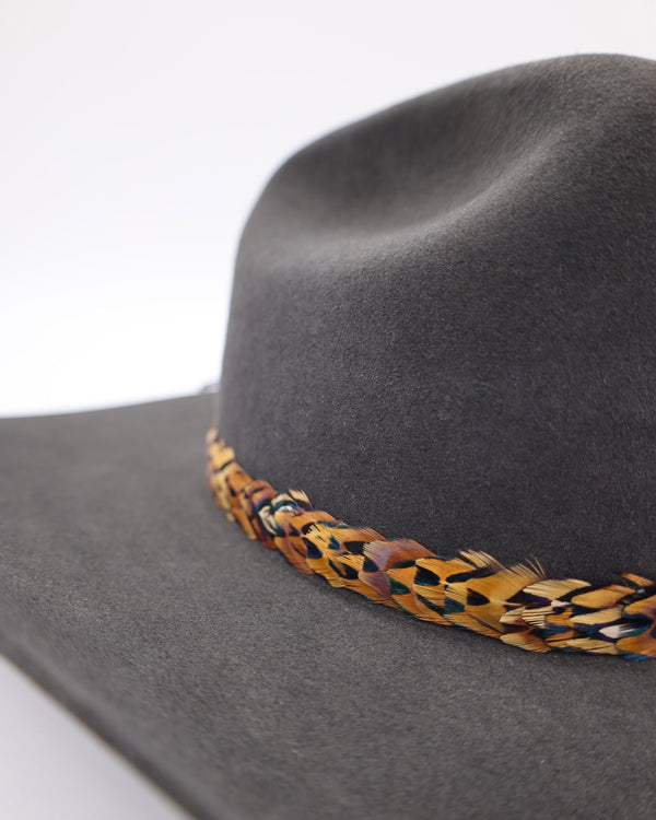 Pheasant feather cowboy hat band displayed on cowboy hat. This listing is only for the feather hat band