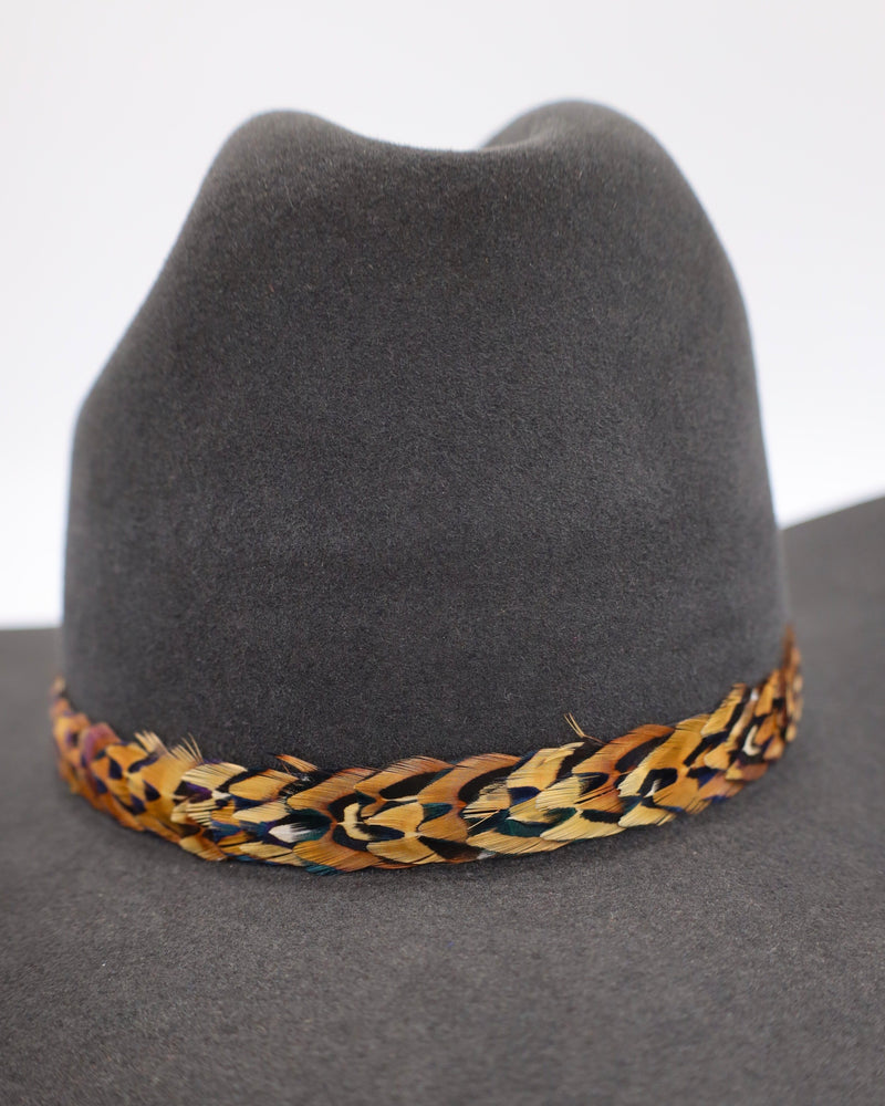 Pheasant feather cowboy hat band displayed on cowboy hat. This listing is only for the feather hat band