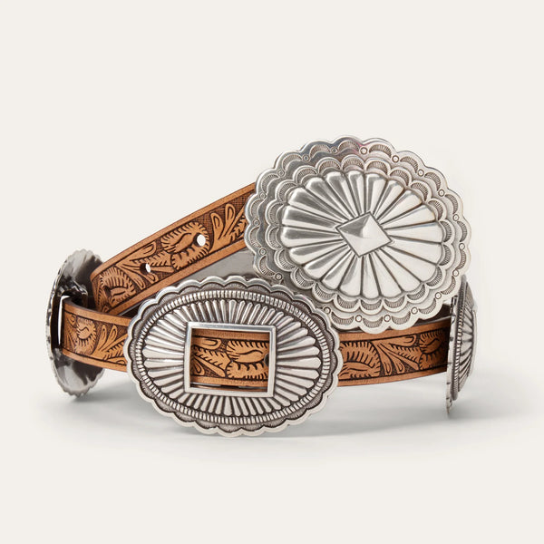 Belt with silver and brown concho design on a light gray background