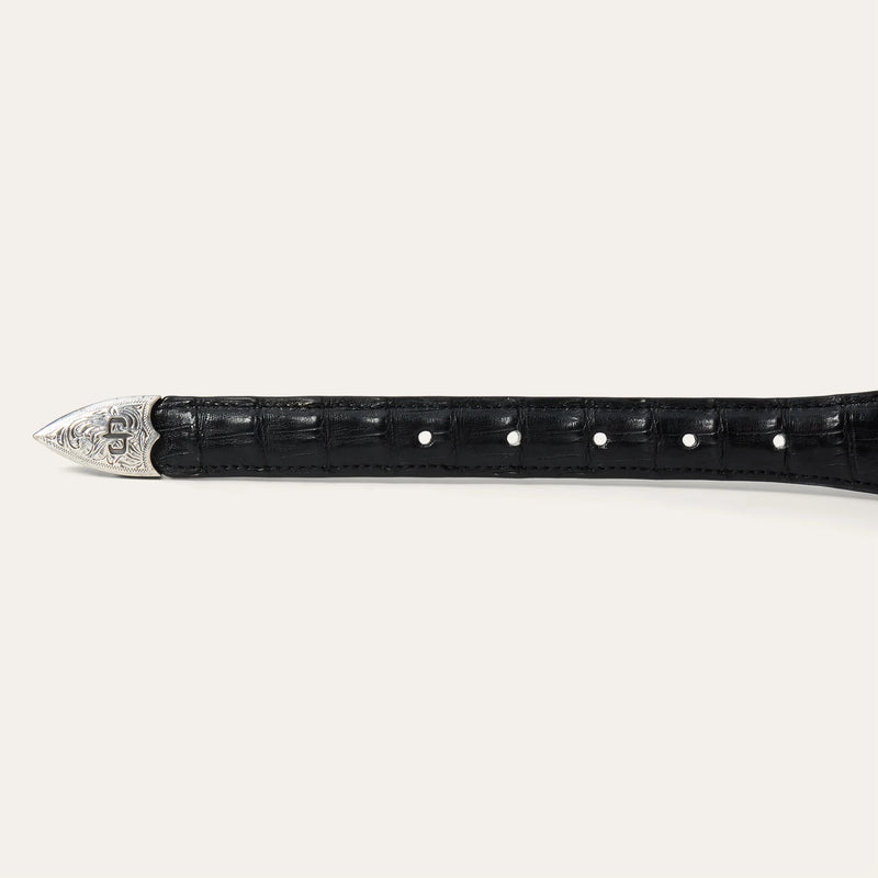 Black crocodile skin belt with silver metal buckle on a white background
