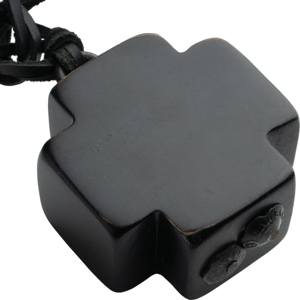 Black hexagonal device with a strap on a white background