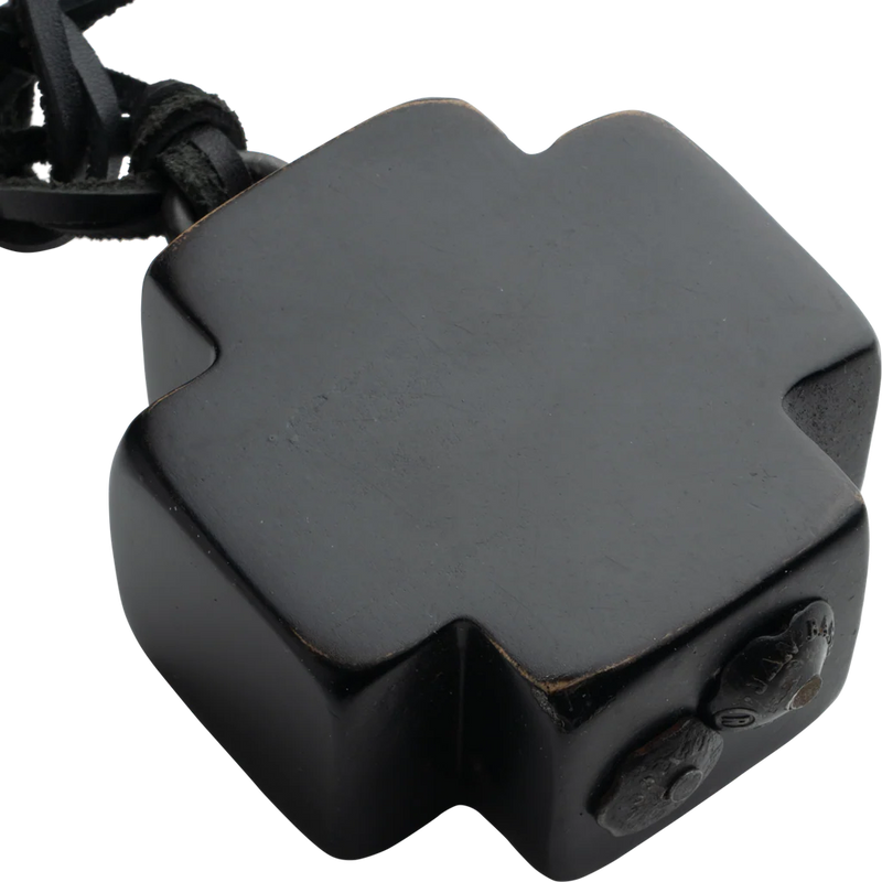Black hexagonal device with a strap on a white background