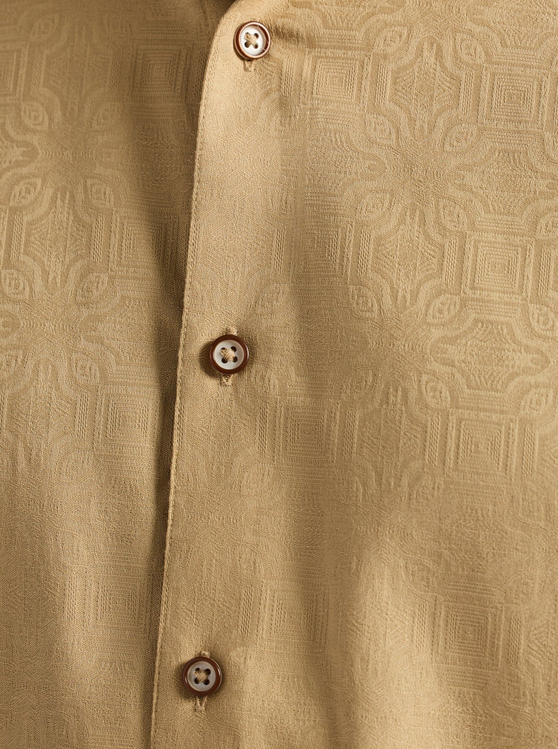 Close-up of a beige textured shirt with buttons