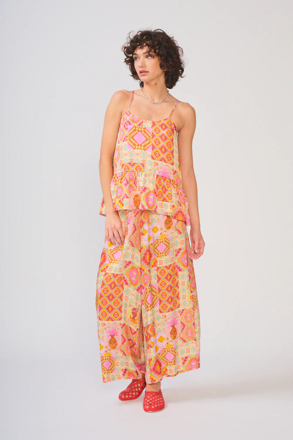 Woman wearing a colorful patterned dress on a white background