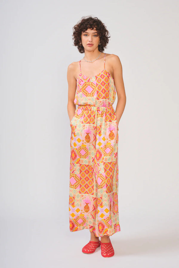 Woman wearing a colorful patterned dress on a white background