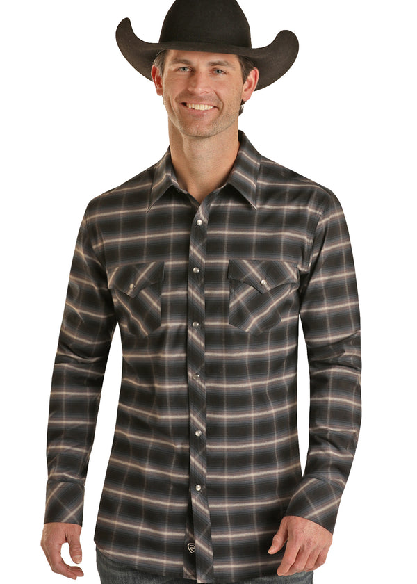 Man wearing black, white, blue and grey plaid button down shirt with double snap breast pockets