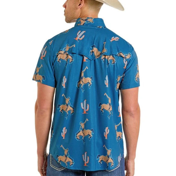 Man wearing a blue shirt with cowboy pattern on a white background