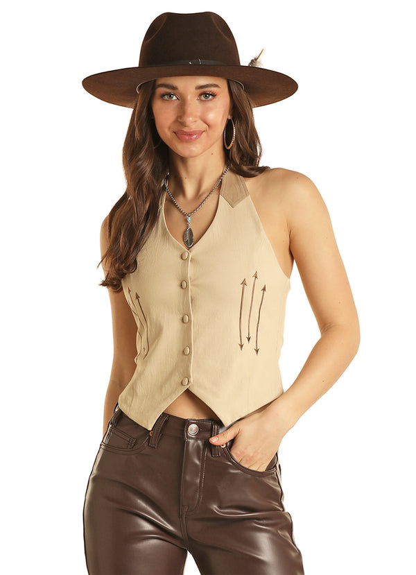 Woman wearing tan vest as shirt with western embroidery and cinch on back