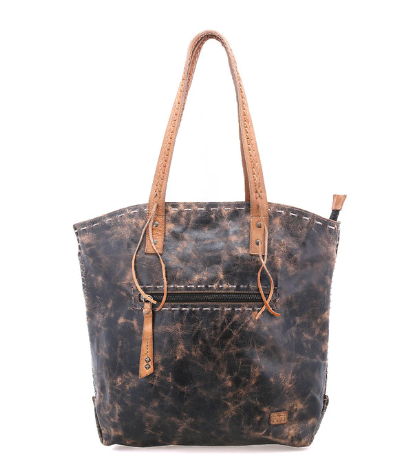Waxed canvas tote bag with leather handles on a white background