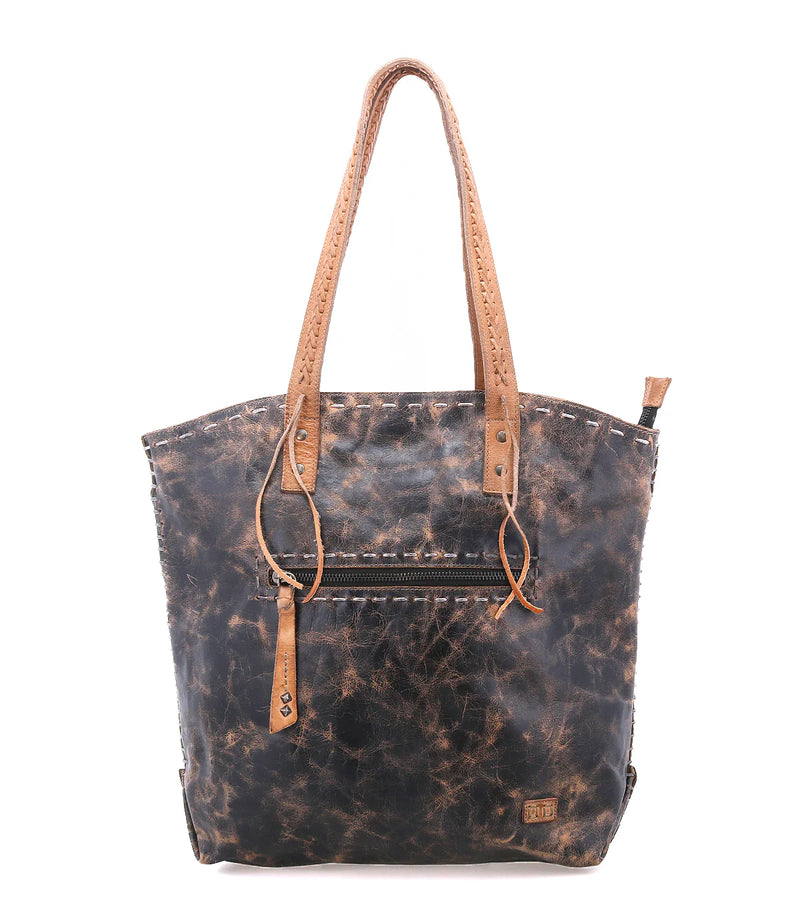 Waxed canvas tote bag with leather handles on a white background