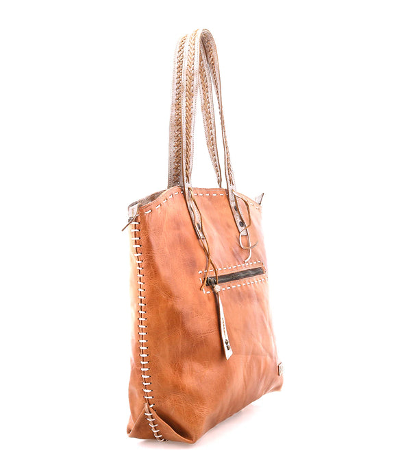 Brown leather handbag with braided handle on a white background