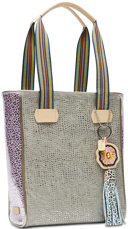 Textured tote bag with pink cheetah print side with flower tassel charm hanging off of stripe handles