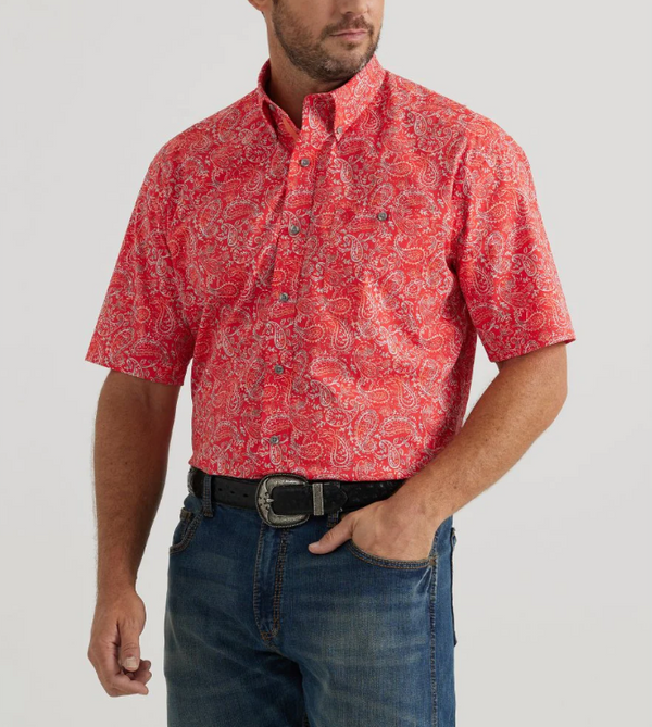 Man wearing button up short sleeve shirt with paisley print all over