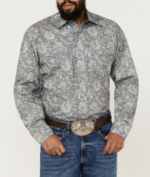 Man wearing long sleeve pearl snap shirt with paisley print all over, double breast pockets, and western yokes. This shirt is in a grey, white and blue color scheme