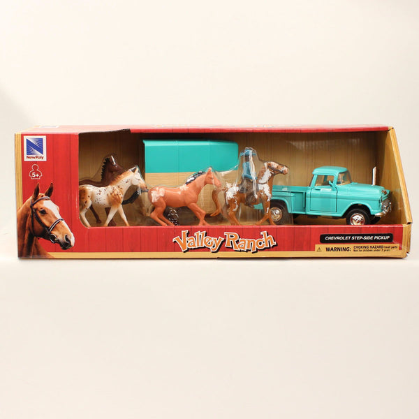 Blue toy truck and trailer with four toy horses with cowboy 