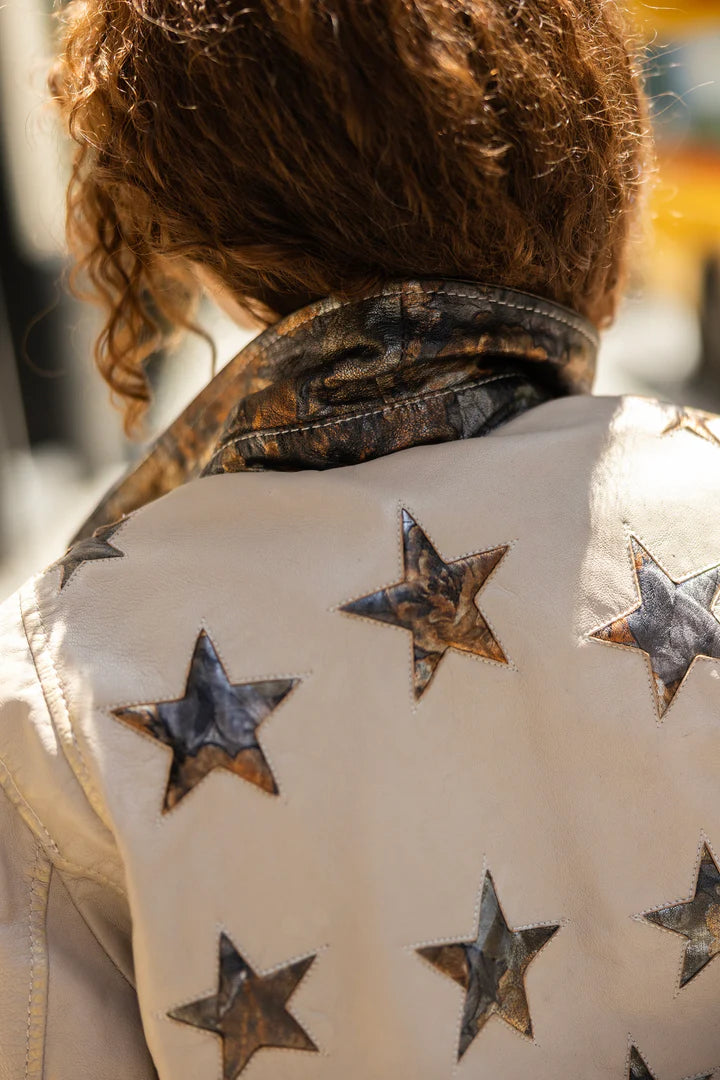 Star jacket with silver and gold on cream jacket with gold hardware and asymmetrical zipper 