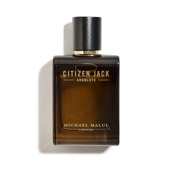 Cologne bottle in amber glass with black top and gold writing spelling out "Citizen Jack Absolute Michael Malul London"