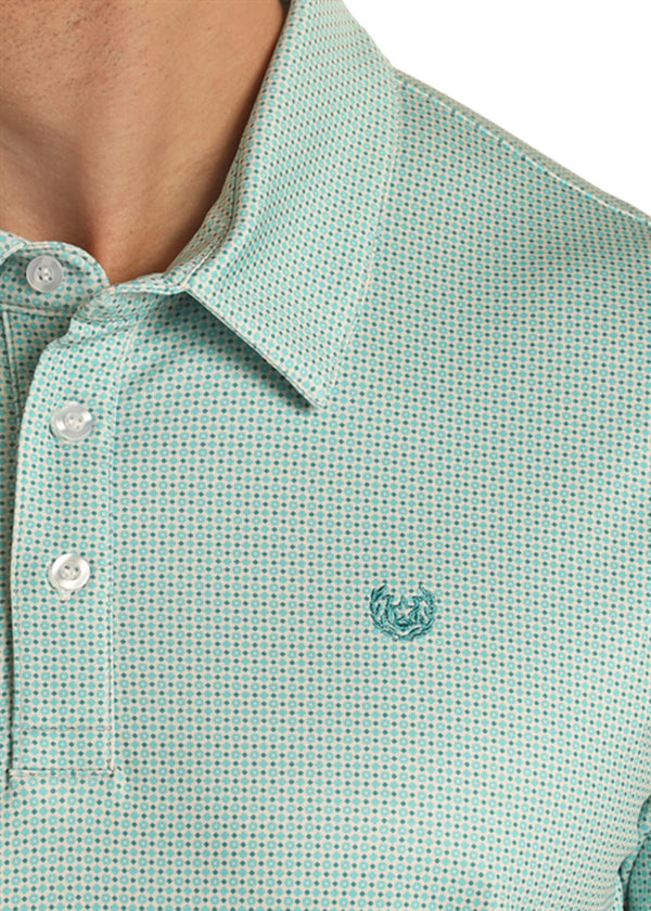 Man wearing short sleeve polo with turquoise geo pattern