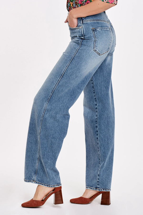 Woman wearing super high rise wide hem loose straight leg jeans.