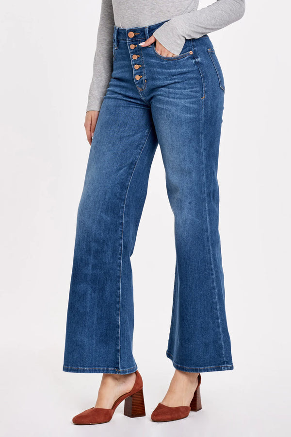 Woman wearing super high rise wide leg jeans with button up front 
