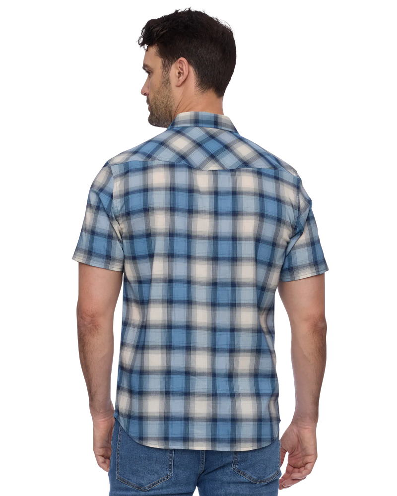 Man wearing a blue and white plaid shirt on a white background