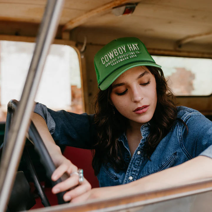 Green foam trucker hat with script "COWBOY HAT SENDERO PROVISIONS CO. TRADEMARK 2014" on front.