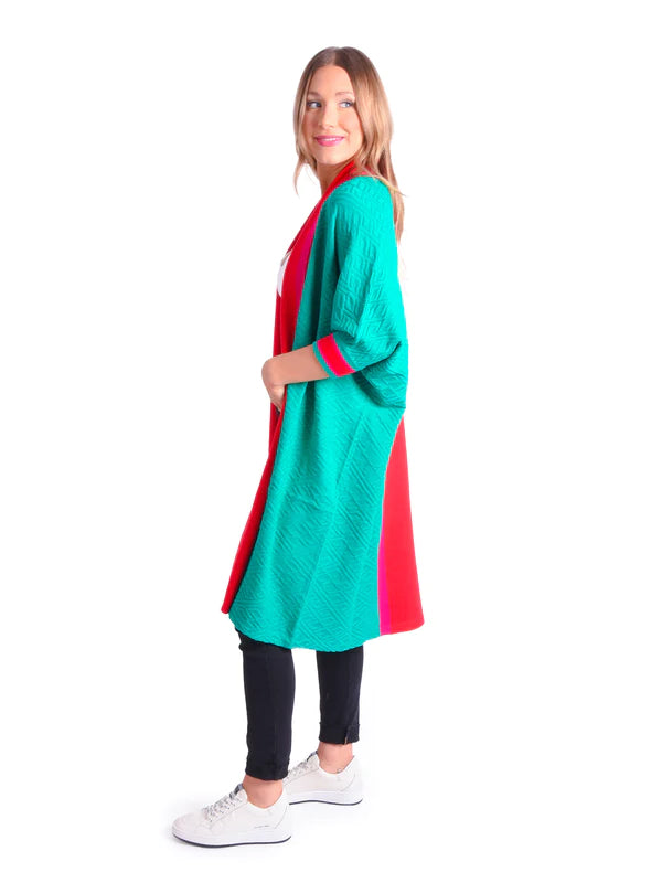 Long green cardigan with quarter sleeves and pink and red accent striped on cuff, collar and down the center of the back