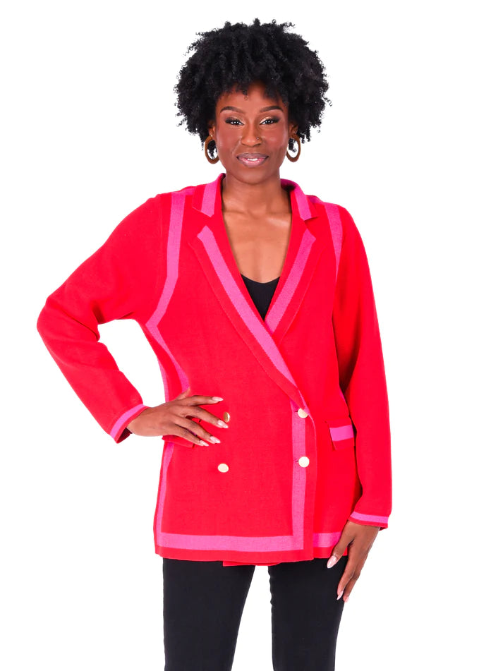 Woman wearing knit red with pink accent blazer with shiny gold buttons