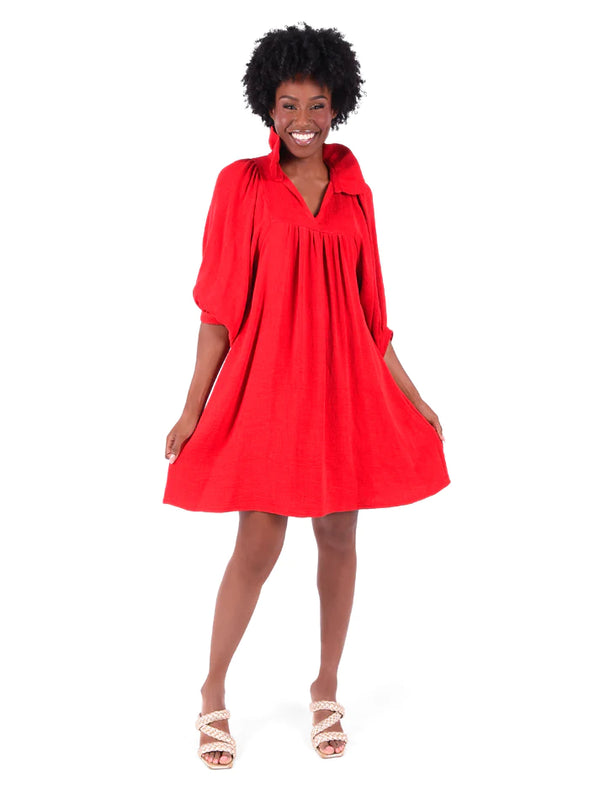 Woman wearing red high ruffled collar dress