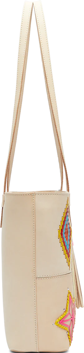 Cream leather tote purse with Aztec, bird, star sun with face and ray embroidered into the bag with concho tassel on the handle