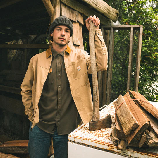 MAN HOLDING AXE WEARING TAN CANVAS ZIPJACKET WITH POCKET