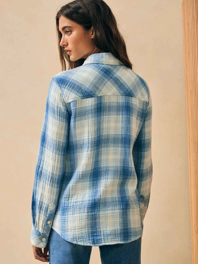 Woman wearing blue and white button down plaid shirt