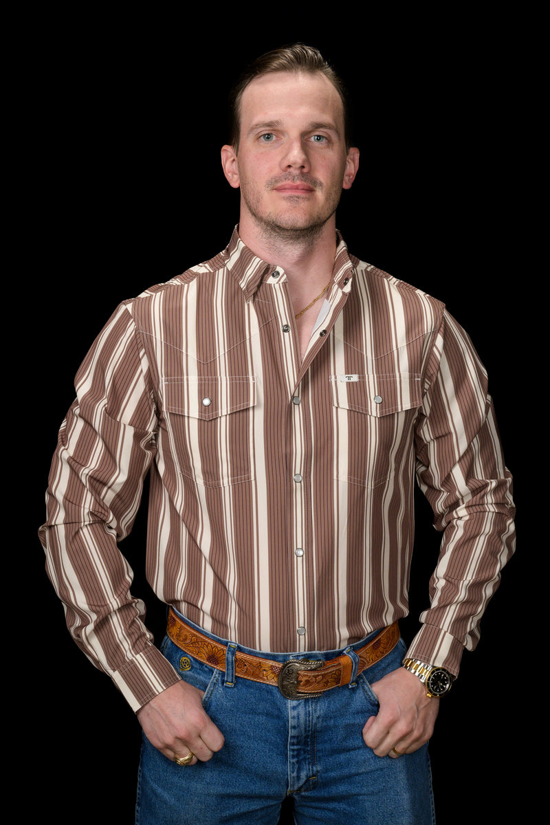 Man wearing a brown and white striped shirt with blue jeans on a black background
